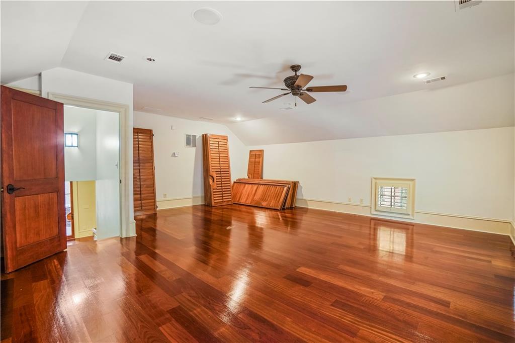 5102 Park Street Covington, GA 30014 - Photo 24 of 97 a view of an empty room with wooden floor and a ceiling fan
