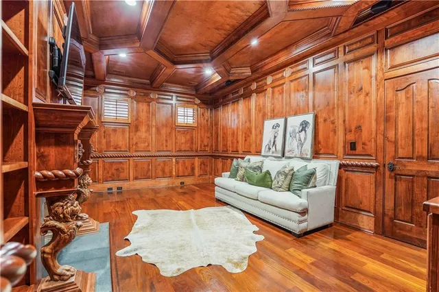 a living room with a balcony furniture and a fireplace