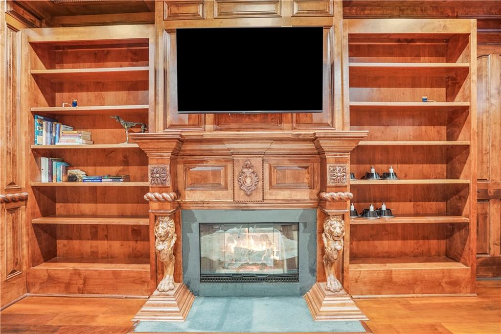 5102 Park Street Covington, GA 30014 - Photo 28 of 97 a living room with a fireplace and a flat screen tv