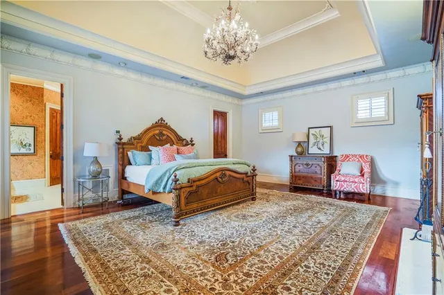 a view of a bedroom with wooden floor and a window