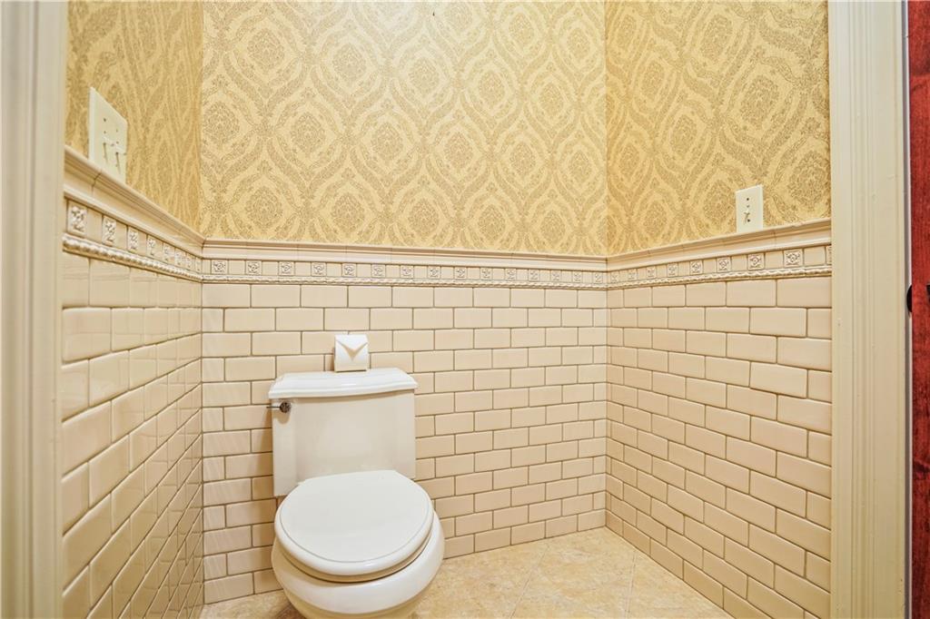 5102 Park Street Covington, GA 30014 - Photo 70 of 97 a bathroom with a toilet and a shower