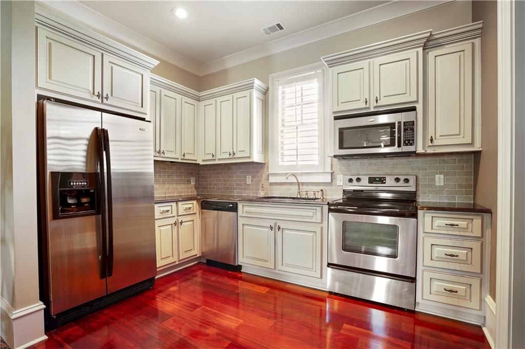 5102 Park Street Covington, GA 30014 - Photo 81 of 97 a kitchen with stainless steel appliances granite countertop a refrigerator stove and sink