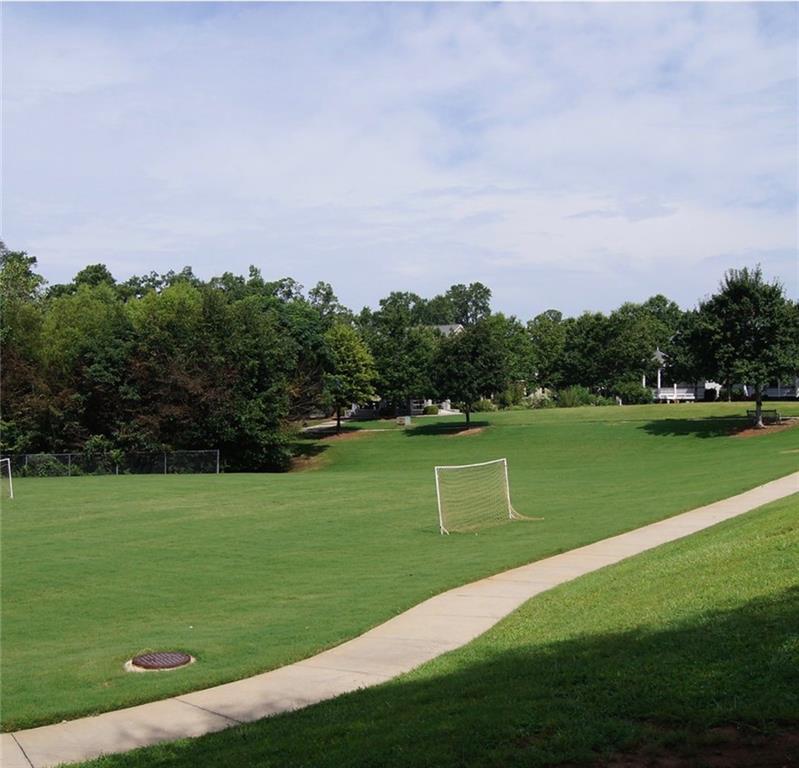 5102 Park Street Covington, GA 30014 - Photo 96 of 97 a view of a golf course with a lake