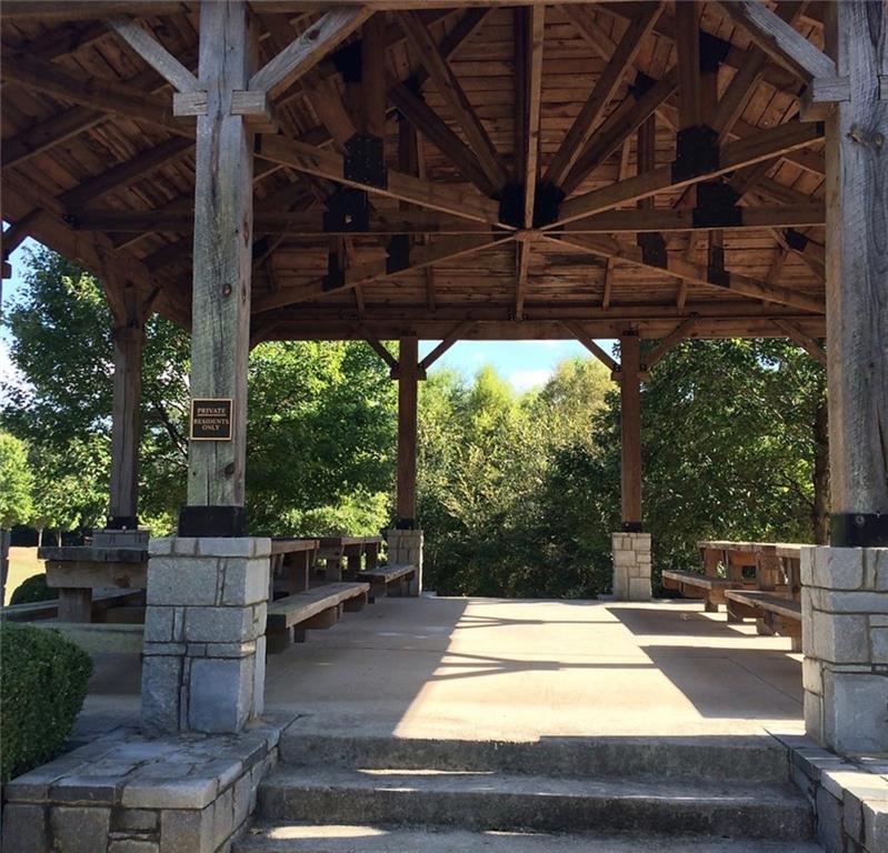 5102 Park Street Covington, GA 30014 - Photo 97 of 97 a view of a patio with table and chairs potted plants with wooden floor and fence