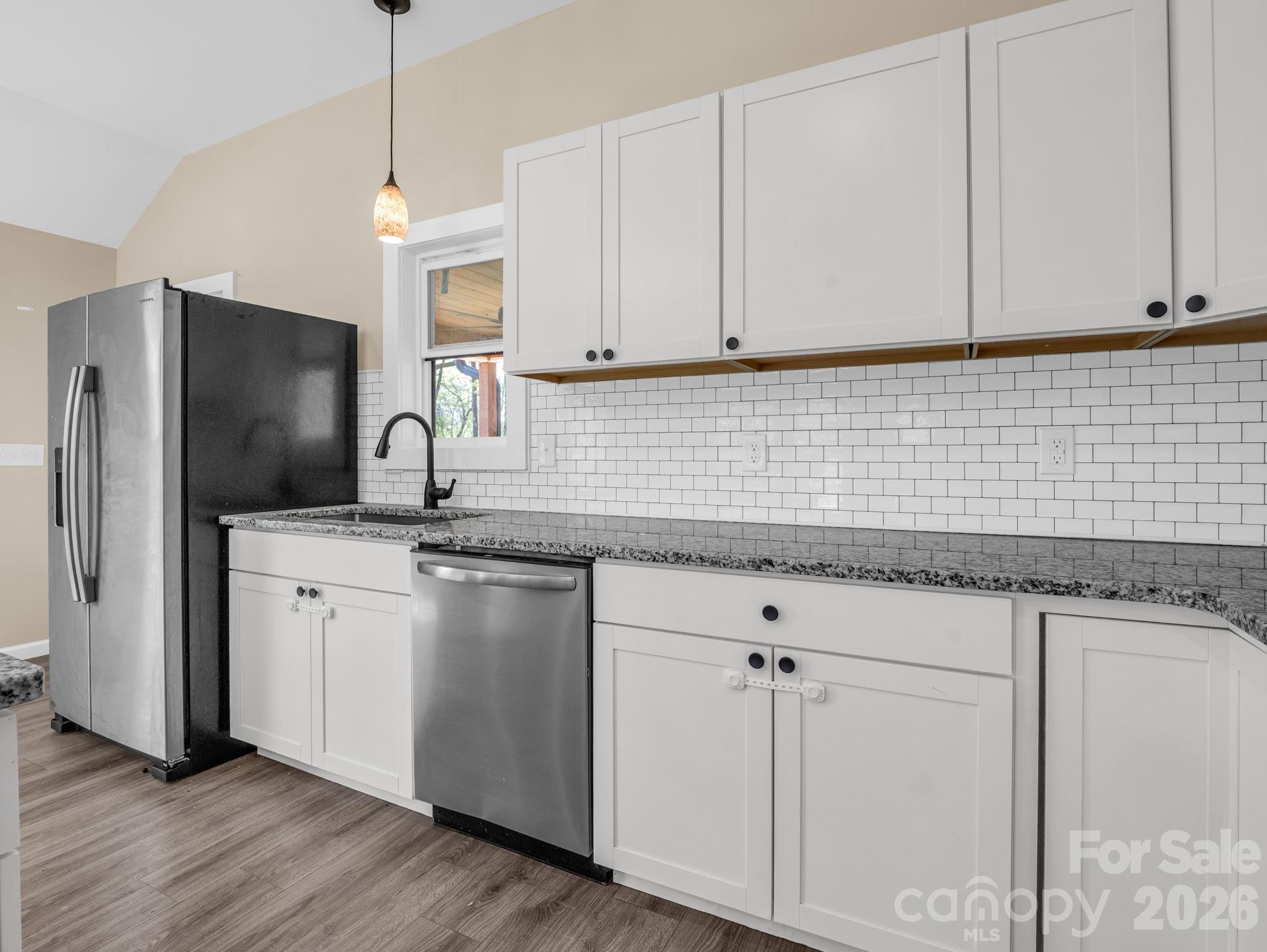1081 Mt Lebanon Church Road Bostic, NC 28018 - Photo 12 of 47 a kitchen with stainless steel appliances granite countertop a sink a stove a refrigerator and cabinets with wooden floor