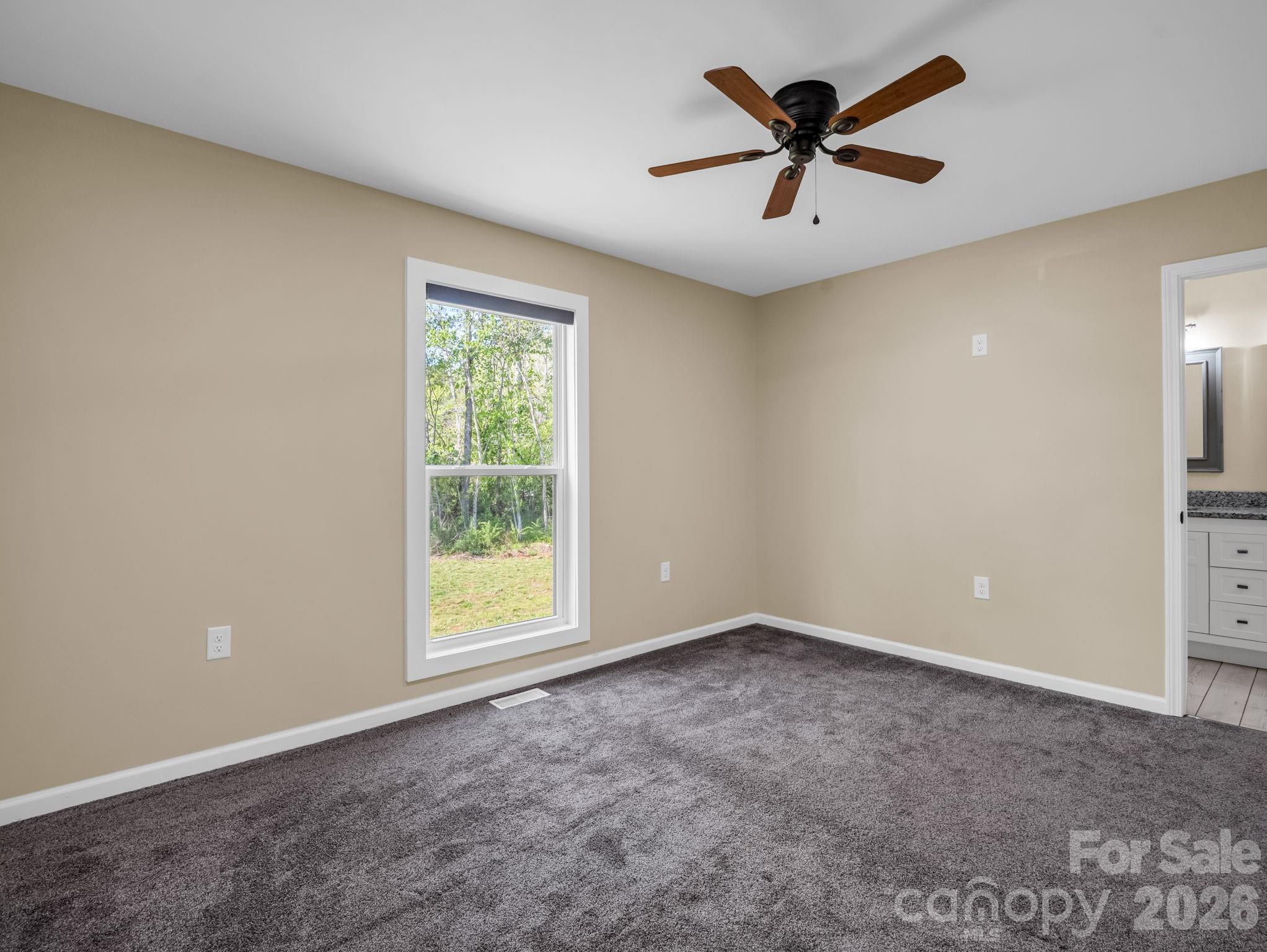 1081 Mt Lebanon Church Road Bostic, NC 28018 - Photo 19 of 47 an empty room with windows and a ceiling fan