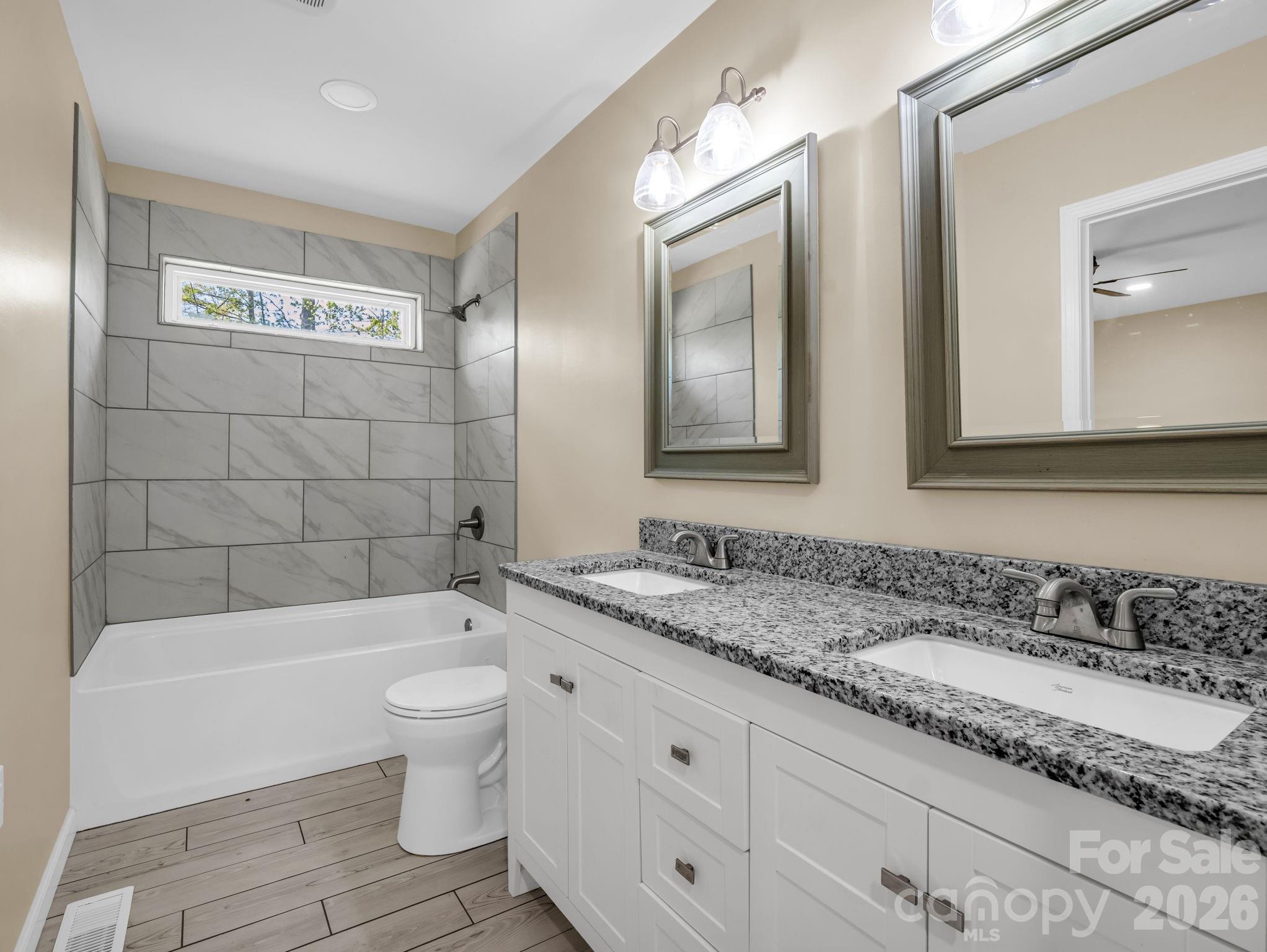1081 Mt Lebanon Church Road Bostic, NC 28018 - Photo 20 of 47 a bathroom with a granite countertop toilet a sink and bathtub