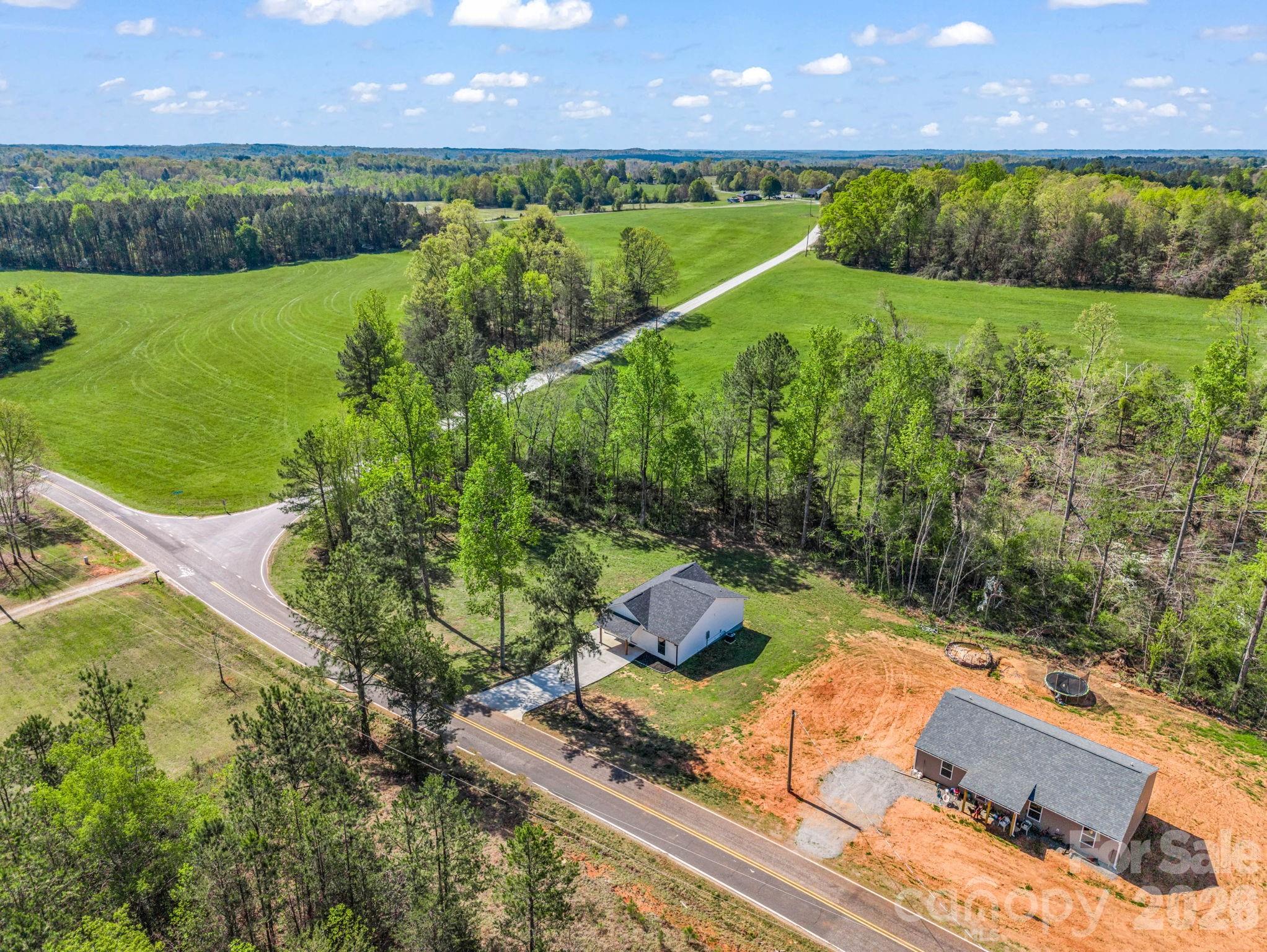 1081 Mt Lebanon Church Road Bostic, NC 28018 - Photo 45 of 47 an aerial view of a house with a yard and lake view