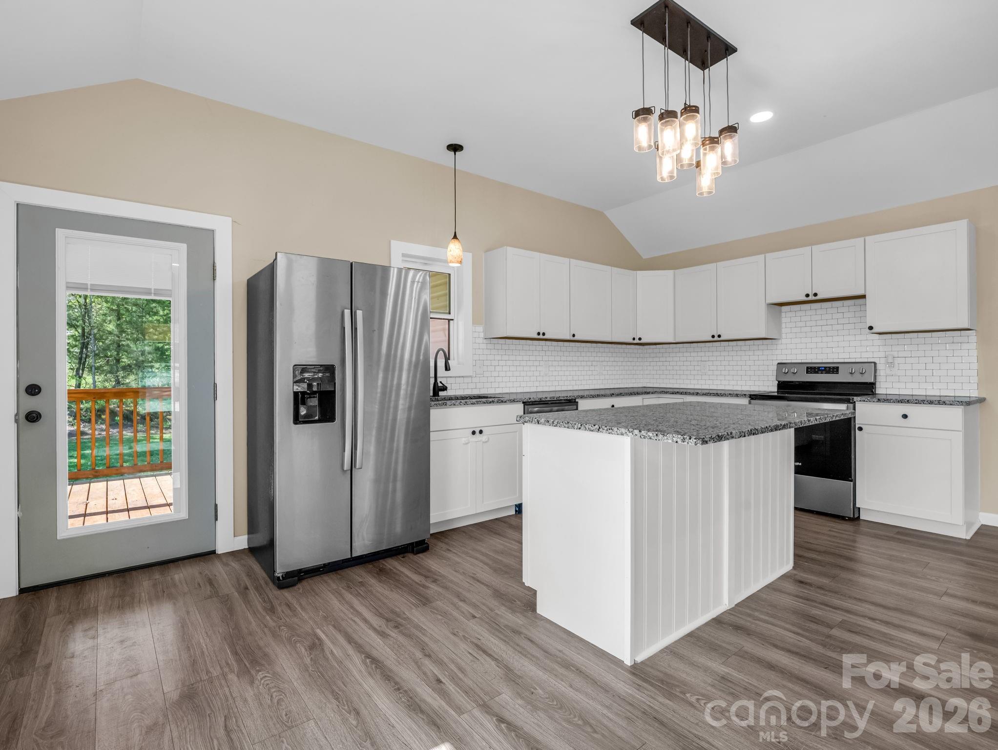 1081 Mt Lebanon Church Road Bostic, NC 28018 - Photo 10 of 47 a kitchen with stainless steel appliances granite countertop a refrigerator a sink dishwasher a stove and white countertops with wooden floor