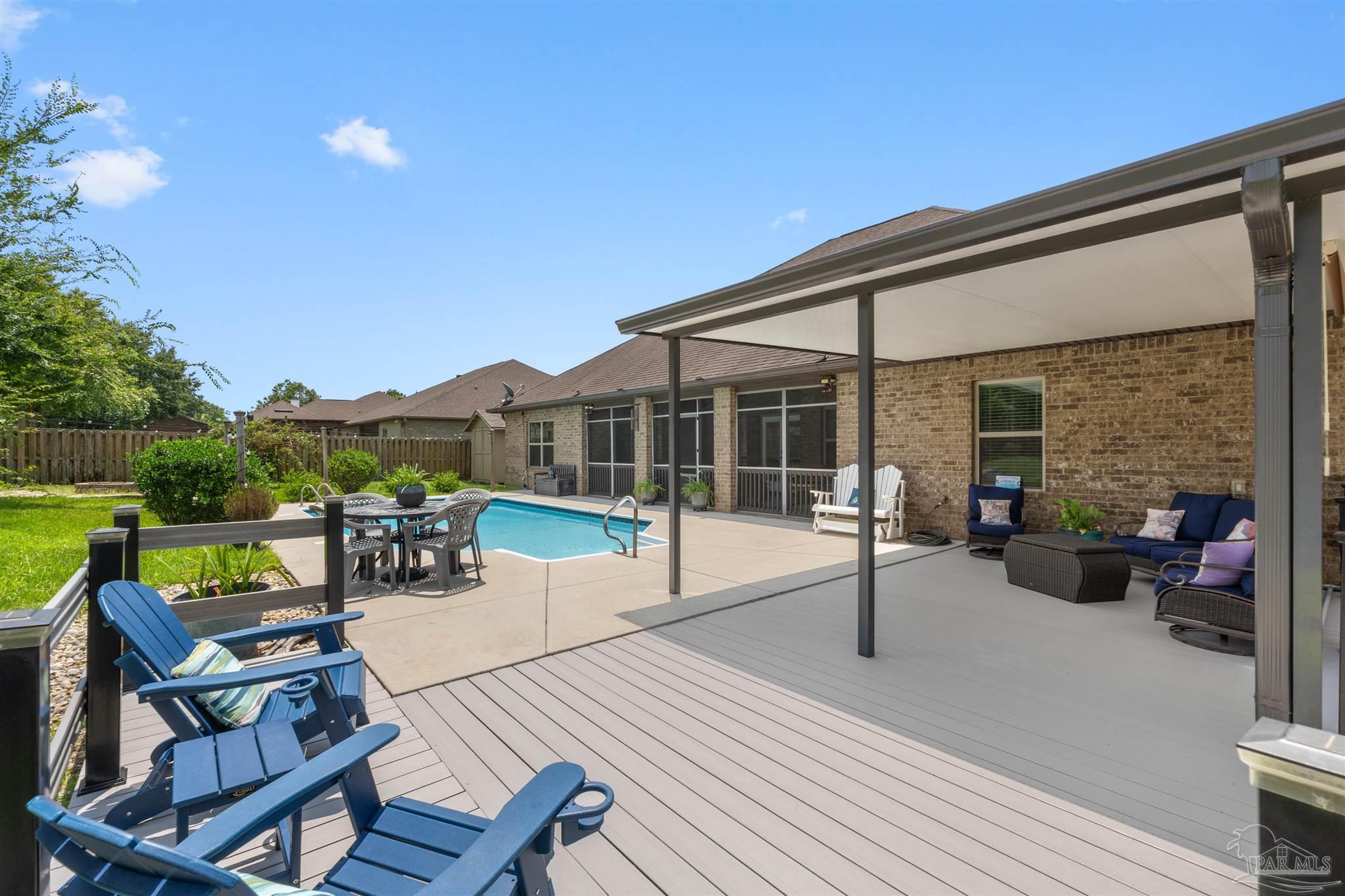 2698 Tulip Hill Road Pace, FL 32571 - Photo 57 of 65 a view of a patio with swimming pool and sitting area
