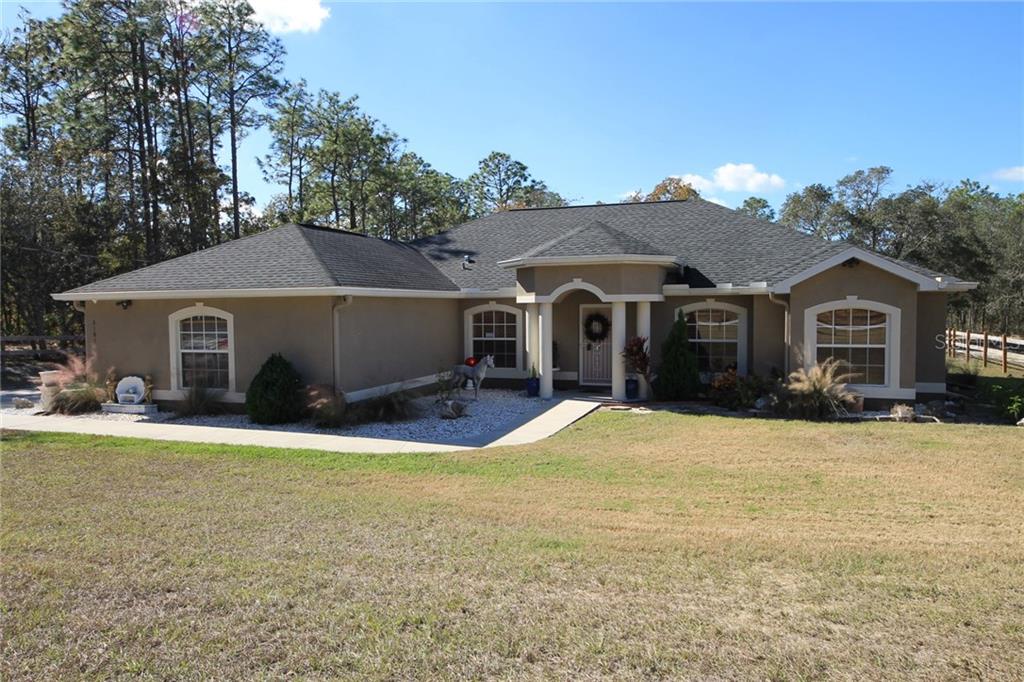 8181 Nightingale Road Weeki Wachee, FL 34613 - Photo 1 of 1 a front view of a house with yard and parking