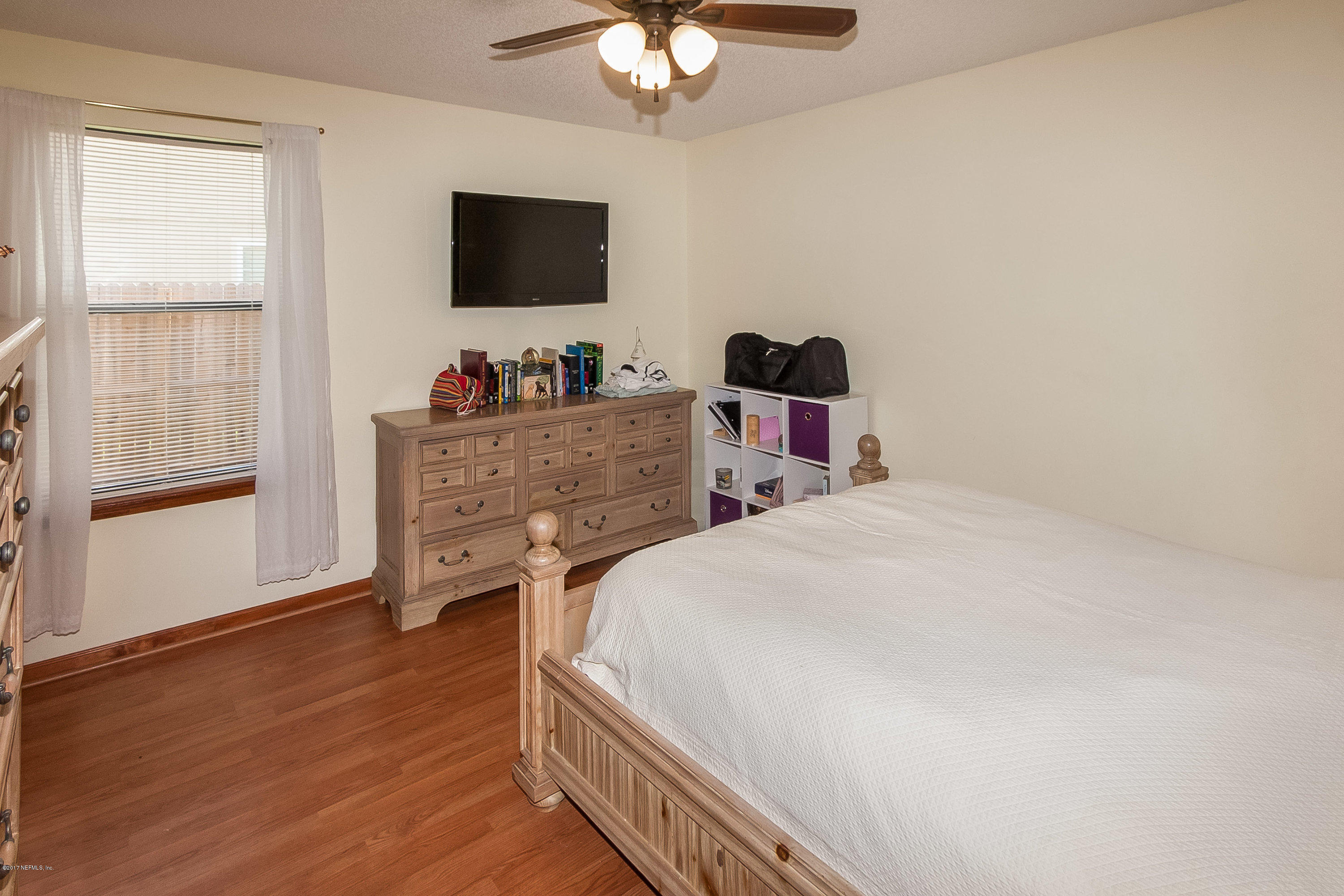 12327 Raleigh Ridge Drive South Jacksonville, FL 32225 - Photo 8 of 26 a bedroom with a bed and a flat screen tv