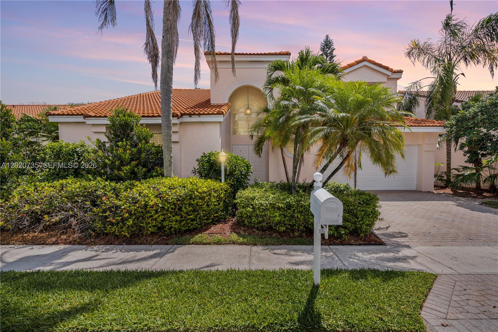 17244 Balboa Point Way Boca Raton, FL 33487 - Photo 1 of 66 a front view of a house with a garden and a yard