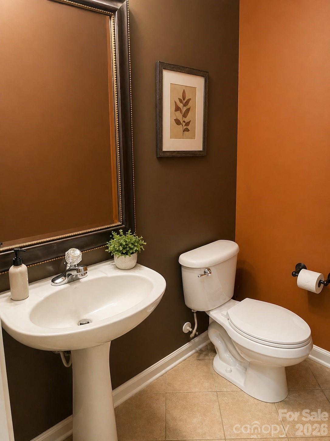 6006 Brook Valley Run Monroe, NC 28110 - Photo 16 of 27 a bathroom with a toilet sink and mirror