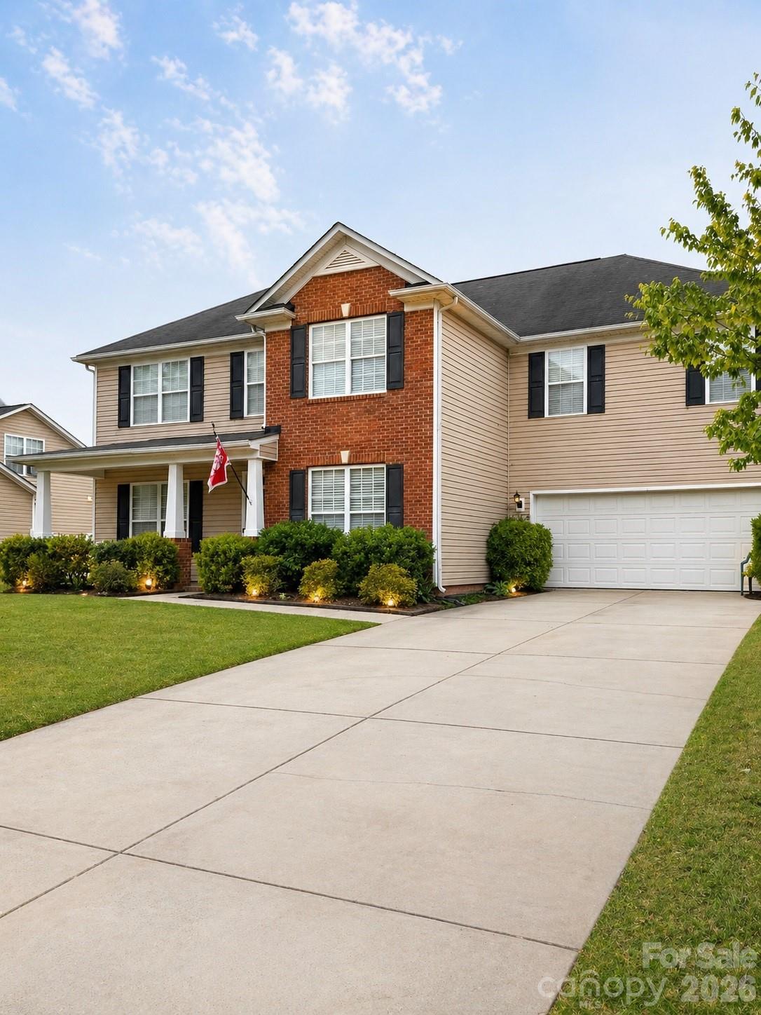 6006 Brook Valley Run Monroe, NC 28110 - Photo 2 of 27 a front view of a house with a yard and garage