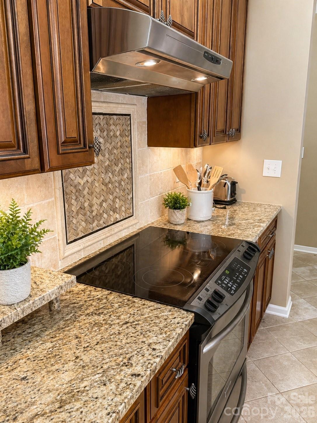 6006 Brook Valley Run Monroe, NC 28110 - Photo 3 of 27 a kitchen with stainless steel appliances granite countertop a stove a sink and a microwave