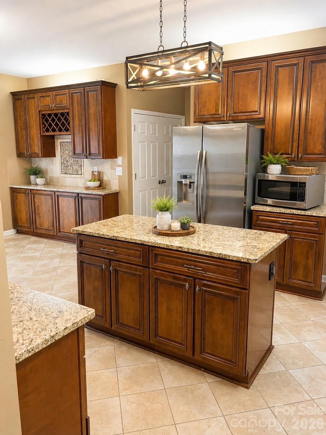 6006 Brook Valley Run Monroe, NC 28110 - Photo 4 of 27 a kitchen with stainless steel appliances wooden cabinets a sink and a counter space