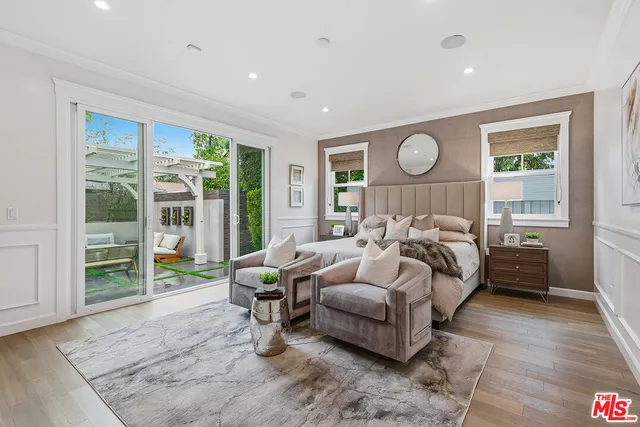 a bed room with a bed and a large window