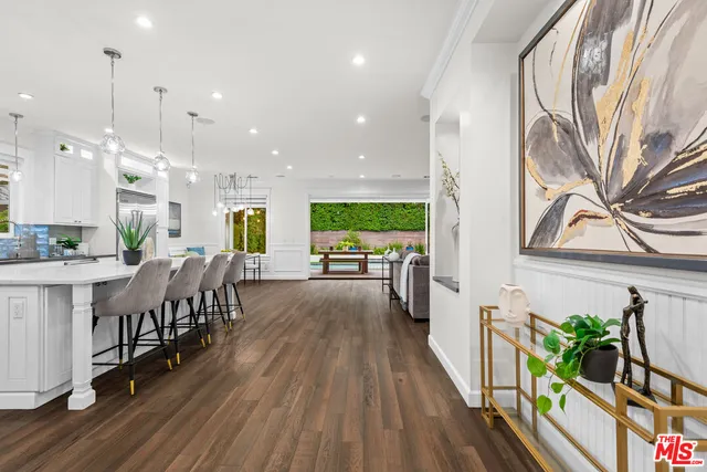 a dining room with furniture and wooden floor