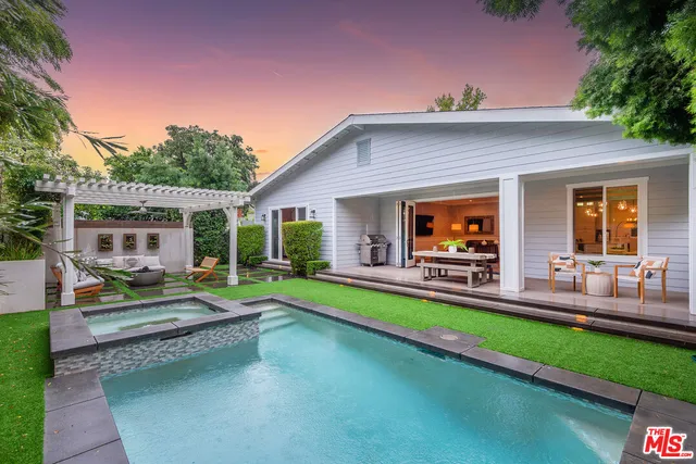 a view of a house with swimming pool and sitting area