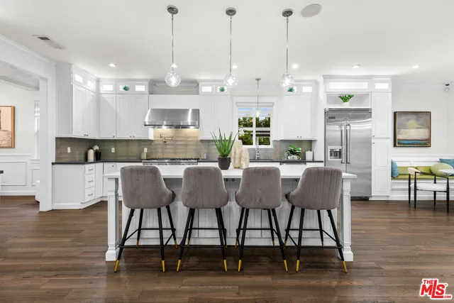 a large kitchen with a table and chairs
