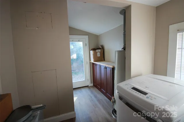 a view of a bedroom with wooden floor