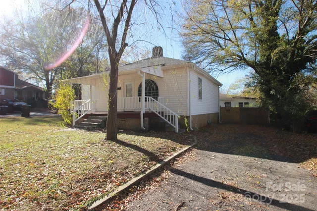 a view of a house with a yard covered in snow