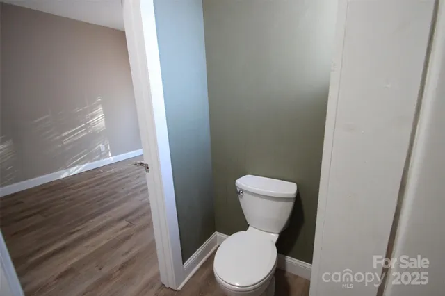 a white toilet sitting next to a shower