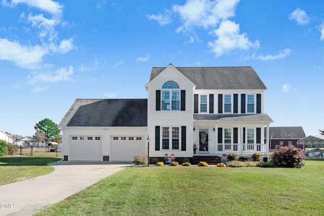 a front view of a house with a garden and plants