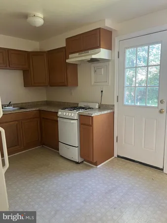 a kitchen with a stove and cabinets