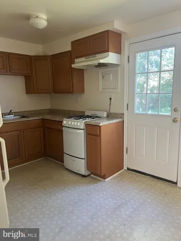 a kitchen with a stove and cabinets