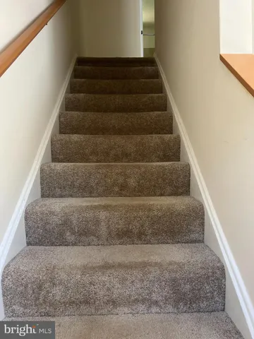 a view of staircase with white walls
