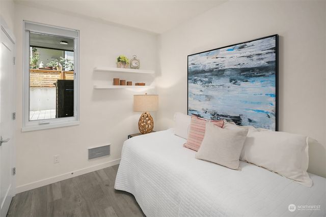 a bedroom with a bed and a painting on the wall