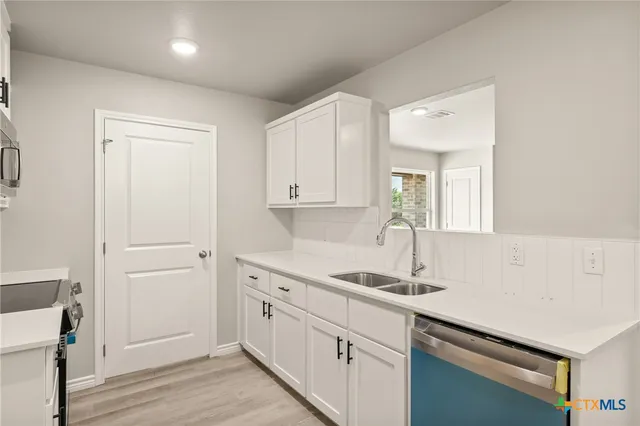 a kitchen with a sink and cabinets