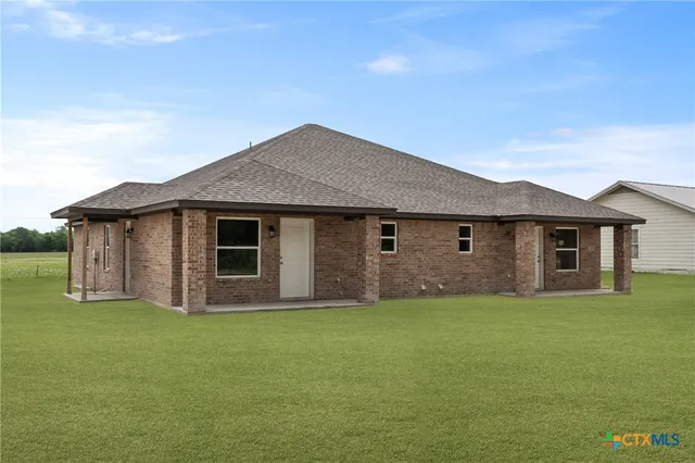 a house that has a big yard in front of it