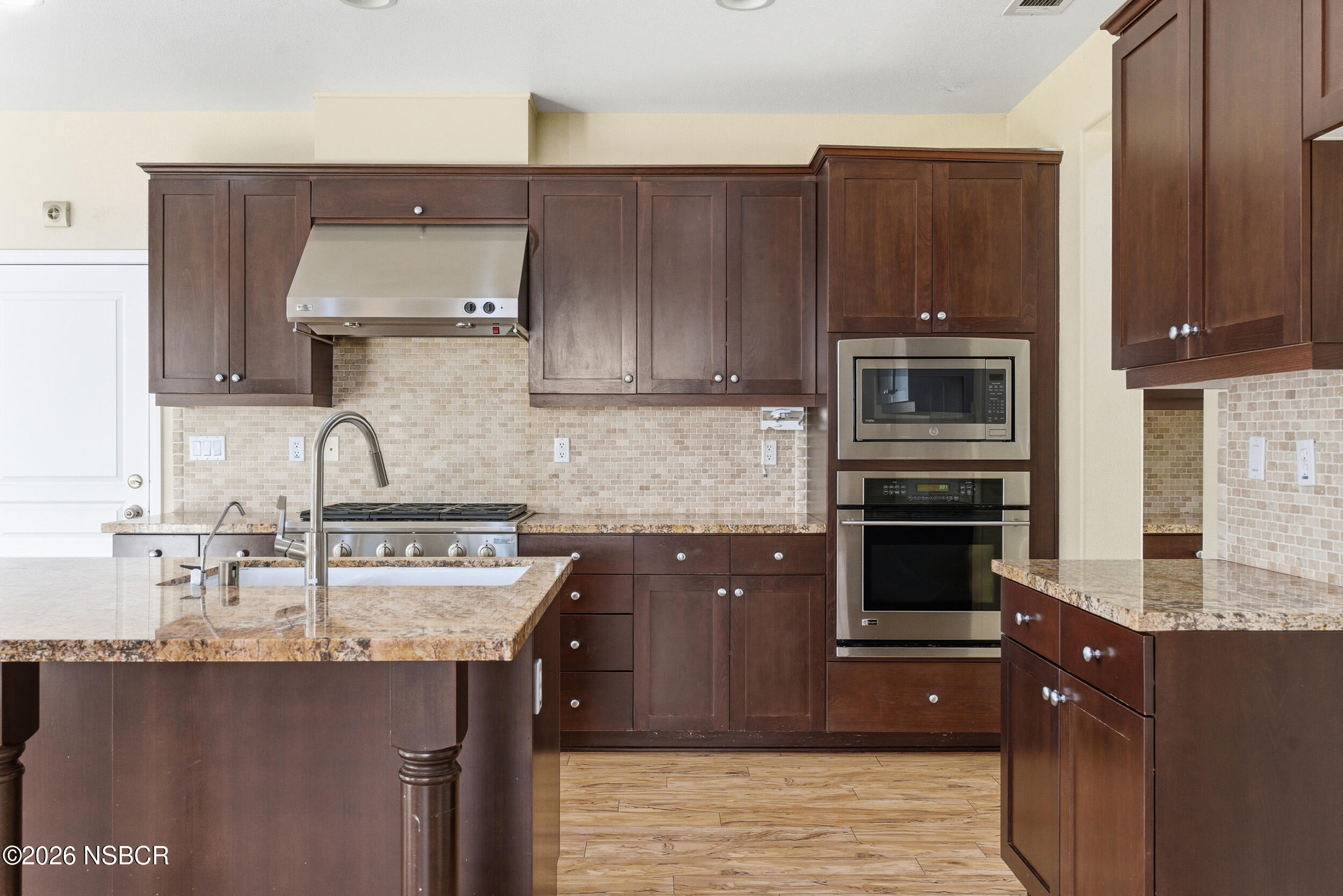5632 Menemsha Lane Santa Maria, CA 93455 - Photo 8 of 66 a kitchen with a sink and wooden cabinets