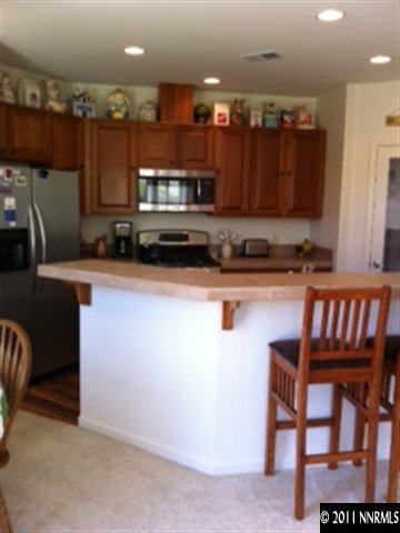 2250 Indian Reno, NV 89521 - Photo 3 of 13 a kitchen with stainless steel appliances granite countertop a sink refrigerator and microwave