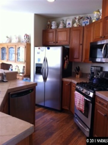 2250 Indian Reno, NV 89521 - Photo 4 of 13 a kitchen with stainless steel appliances granite countertop a stove a refrigerator and a microwave