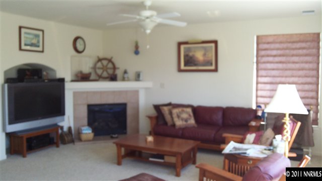 2250 Indian Reno, NV 89521 - Photo 6 of 13 a living room with furniture a fireplace and a window