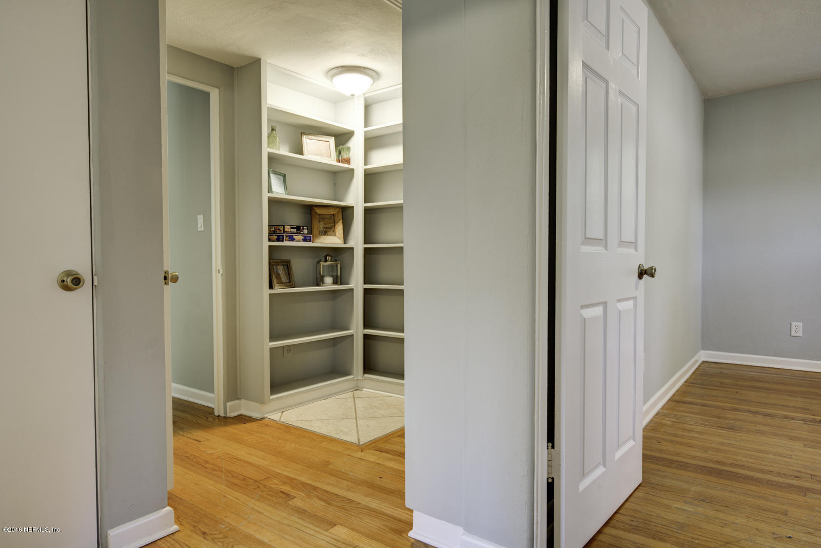 1726 Clemson Road Jacksonville, FL 32217 - Photo 29 of 44 a view of a bedroom with wooden floor and closet