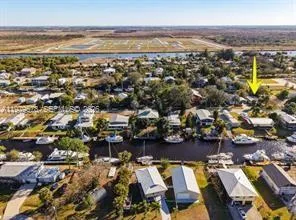 an aerial view of a city with lots of residential buildings and ocean view