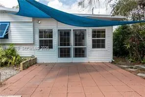 a view of a house with a large window and a yard