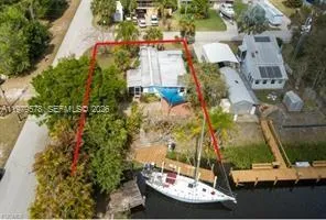 an aerial view of a houses with a yard