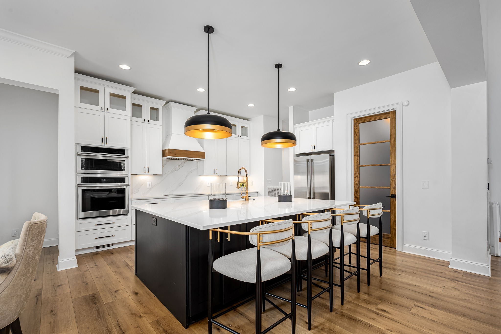 1425 Fuston Hollow Road Auburntown, TN 37016 - Photo 35 of 100 a kitchen with stainless steel appliances kitchen island granite countertop a table chairs and a wooden floor
