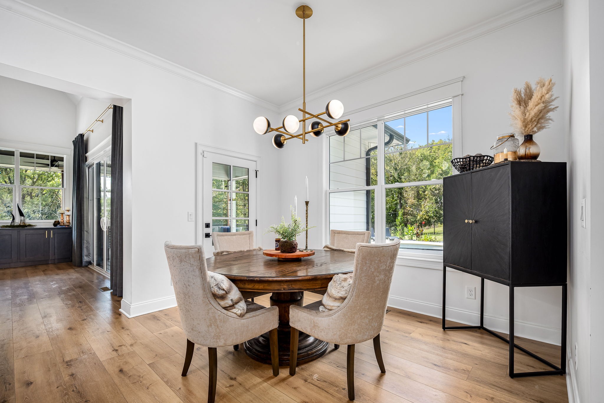 1425 Fuston Hollow Road Auburntown, TN 37016 - Photo 49 of 100 a dining room with furniture potted plants and wooden floor