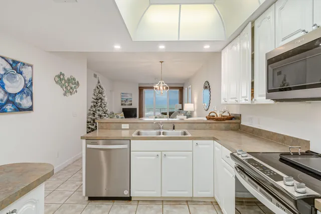 a kitchen with stainless steel appliances a sink stove and refrigerator