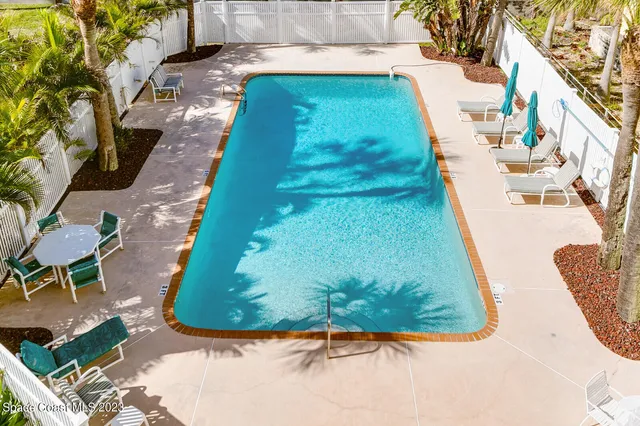 a view of a swimming pool with a yard