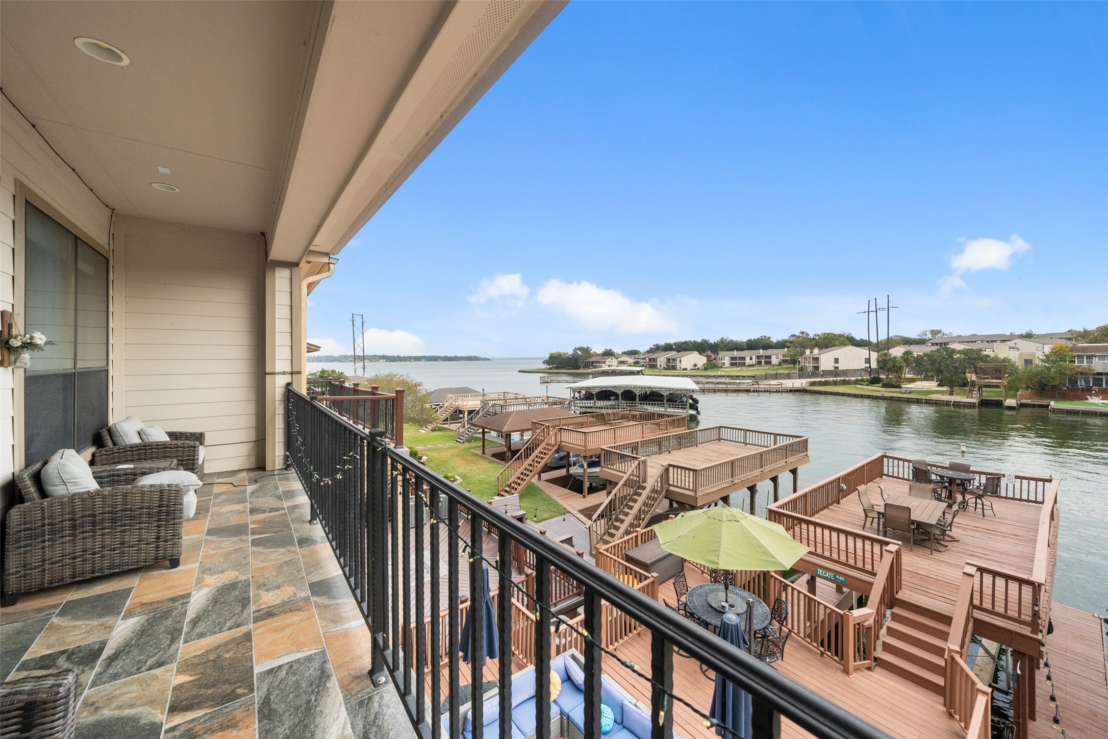 a balcony with wooden floor and lake view