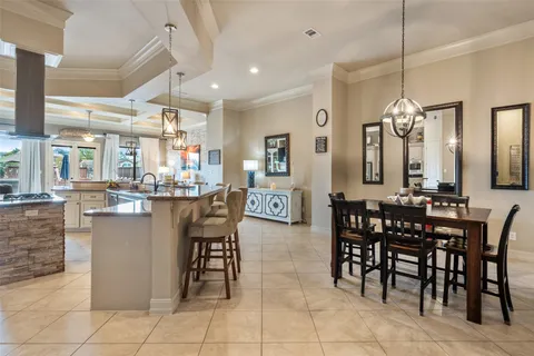 a view of a dining room and livingroom with furniture wooden floor and a chandelier