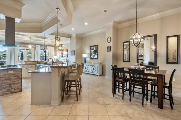 a view of a dining room and livingroom with furniture wooden floor and a chandelier